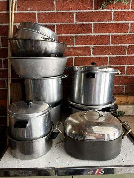 Large group of stainless mixing bowls, pressure cookers, pots and more