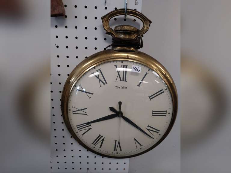 United wall clock shaped like pocket watch Northern Kentucky Auction, LLC