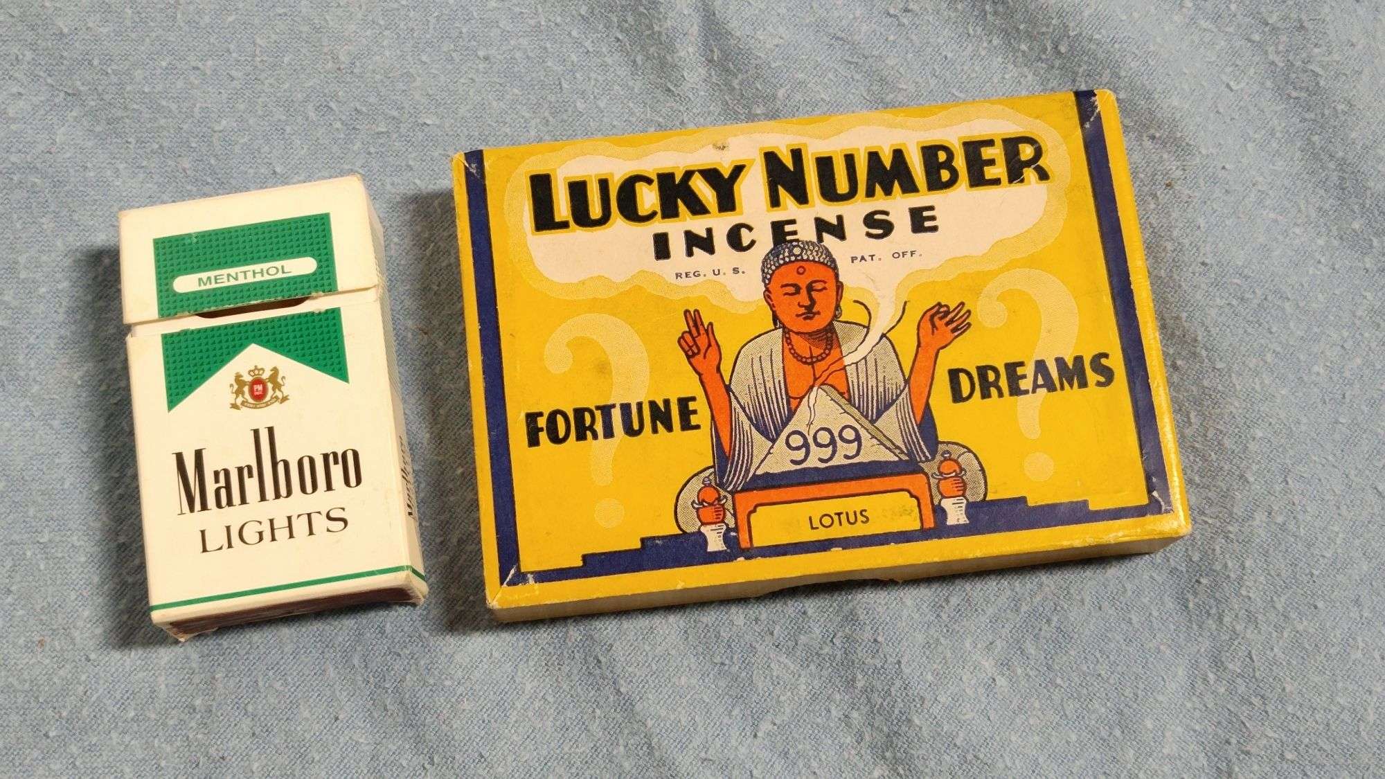 Old Marlboro Light cigarette pack, matches, and Lucky number incense