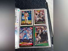 Photo albums of collectible sports cards.