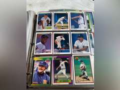 Photo albums of collectible sports cards.