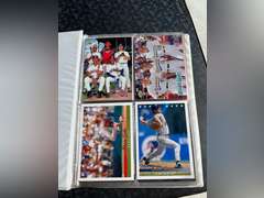 Photo albums of collectible sports cards.