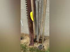 Two man saw, has damaged and a missing handle, double bladed ax, two hose, rake