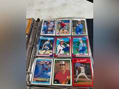 Photo albums of collectible sports cards.