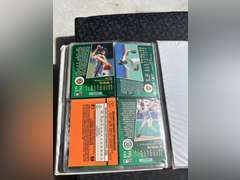 Photo albums of collectible sports cards.