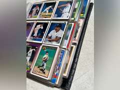 Photo albums of collectible sports cards.