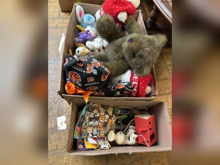 Two boxes with stuffed animals and kids toys