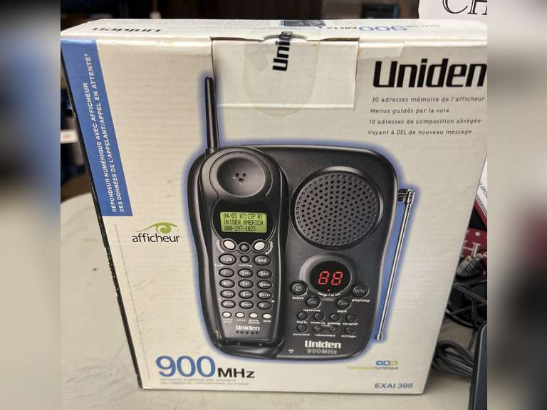 Unidentified cordless telephone in unopened box and Panasonic Link2Cell Cordless phone w/answering machine and 2 additional handsets.