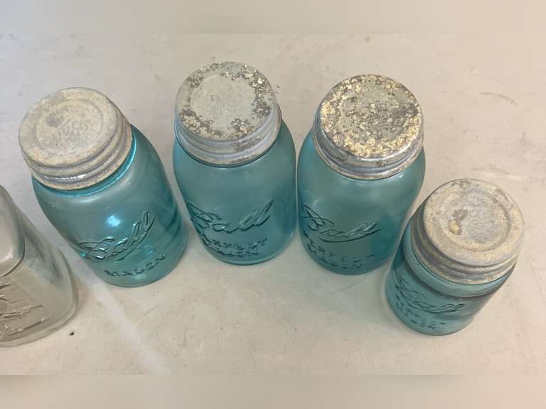 Blue Ball jars with metal caps and 1 clear Mason jar, no lid.