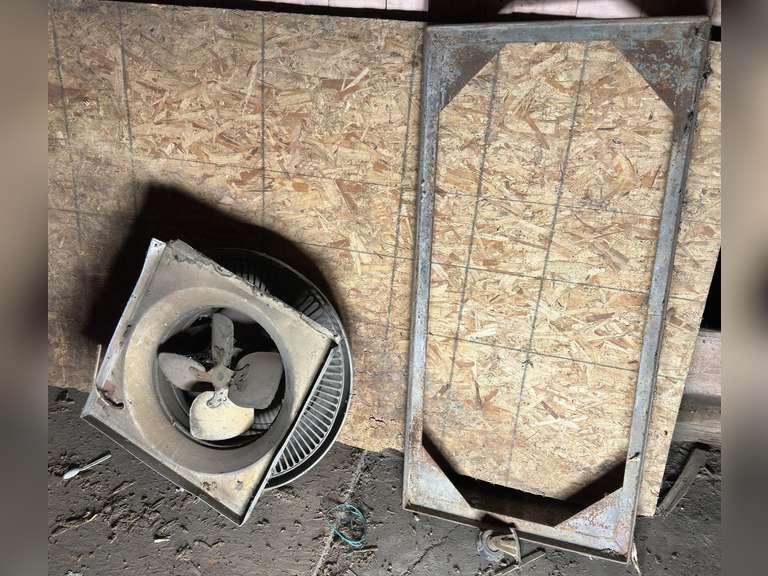 Exhaust fan and metal machinery dolly with 1 broken wheel.