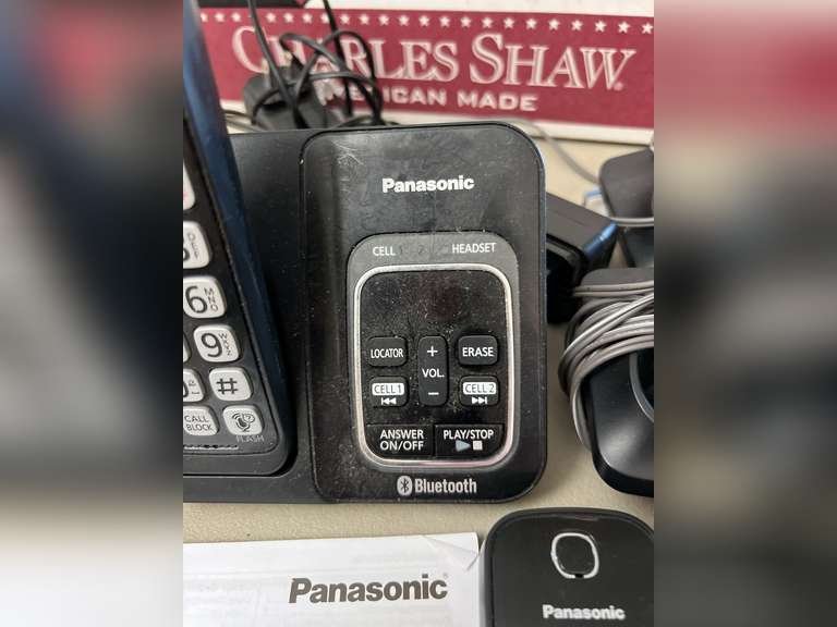 Unidentified cordless telephone in unopened box and Panasonic Link2Cell Cordless phone w/answering machine and 2 additional handsets.