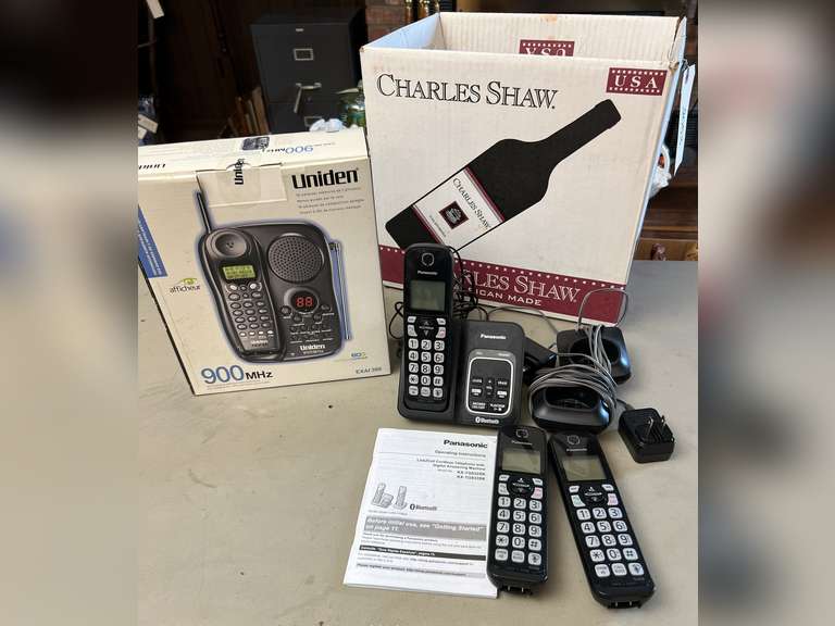 Unidentified cordless telephone in unopened box and Panasonic Link2Cell Cordless phone w/answering machine and 2 additional handsets.
