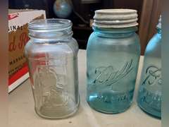 Blue Ball jars with metal caps and 1 clear Mason jar, no lid.