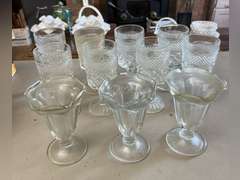 8 Heavy stemmed drinking glasses and 3 sundae glasses.