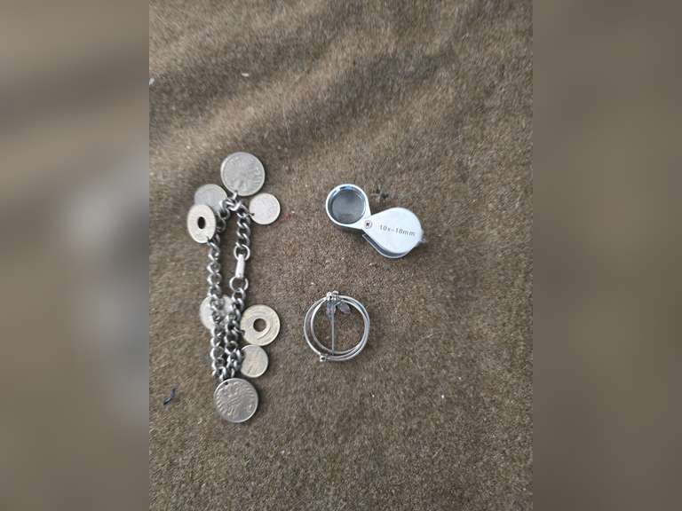 Change purse, straight razor,  bracelet of foreign coins, Brooch, jewelers loupe