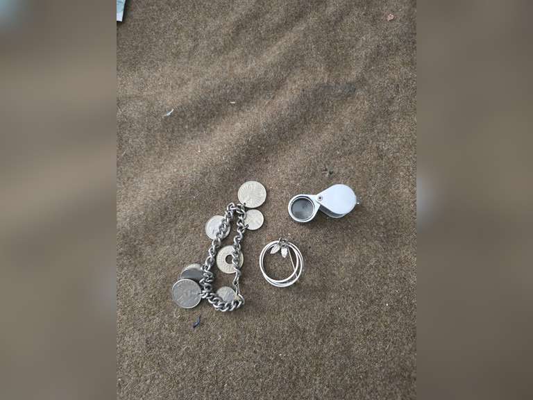 Change purse, straight razor,  bracelet of foreign coins, Brooch, jewelers loupe