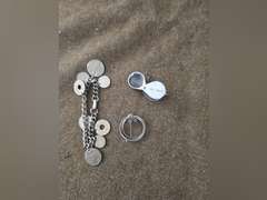 Change purse, straight razor,  bracelet of foreign coins, Brooch, jewelers loupe