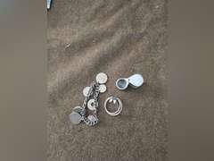 Change purse, straight razor,  bracelet of foreign coins, Brooch, jewelers loupe