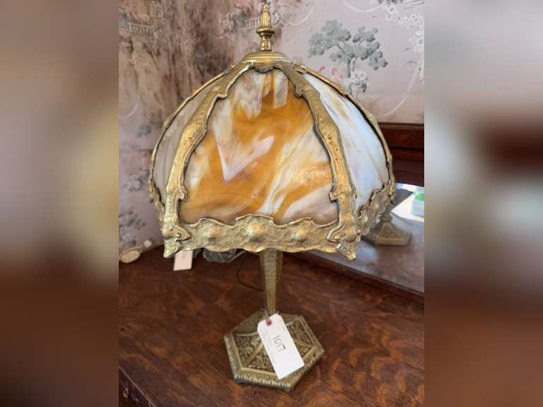 Antique slag glass lamp with ornate gilt metal base.  24” tall. Very heavy lamp. Tested and working.