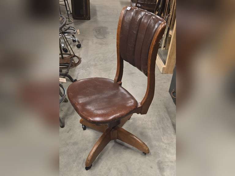 Antique rolling spin around chair, leather covered