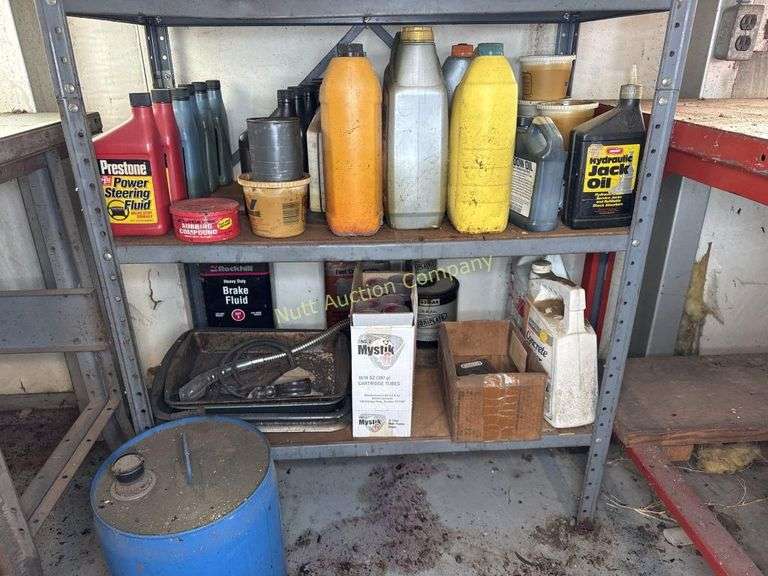Metal cabinet with contents, including motor oil, starting fluid and lubricants