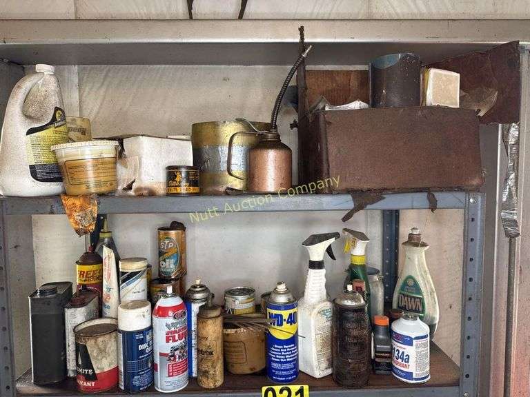 Metal cabinet with contents, including motor oil, starting fluid and lubricants