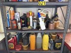 Metal cabinet with contents, including motor oil, starting fluid and lubricants