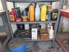 Metal cabinet with contents, including motor oil, starting fluid and lubricants