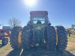 John Deere 8300 Tractor with duals Showing 1410 hours.  200 HP, 4WD, 403.6 hours showing, rear duals, front weights, 3 set of