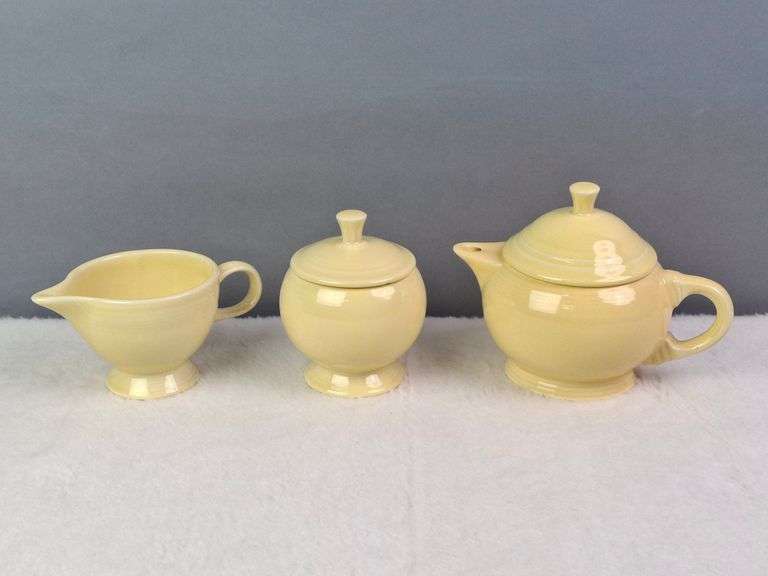 SMALL YELLOW TEA SET, HOMER LAUGHLIN CA, LIDDED TEAPOT, LIDDED SUGAR, AND CREAMER.