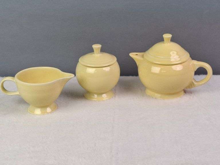 SMALL YELLOW TEA SET, HOMER LAUGHLIN CA, LIDDED TEAPOT, LIDDED SUGAR, AND CREAMER.