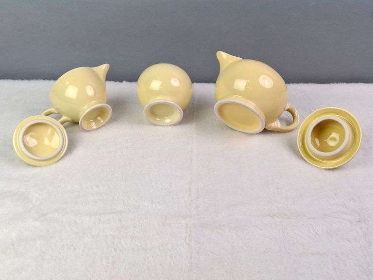 SMALL YELLOW TEA SET, HOMER LAUGHLIN CA, LIDDED TEAPOT, LIDDED SUGAR, AND CREAMER.