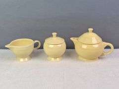 SMALL YELLOW TEA SET, HOMER LAUGHLIN CA, LIDDED TEAPOT, LIDDED SUGAR, AND CREAMER.