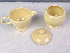 SMALL YELLOW TEA SET, HOMER LAUGHLIN CA, LIDDED TEAPOT, LIDDED SUGAR, AND CREAMER.
