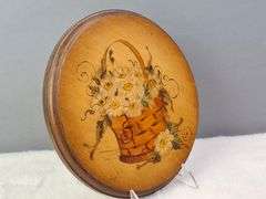 ROUND WOODEN PLAQUE WITH A HAND-PAINTED BASKET FILLED WITH DAISIES, SIGNED FRAN '75, 9.5"W.