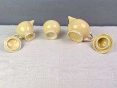 SMALL YELLOW TEA SET, HOMER LAUGHLIN CA, LIDDED TEAPOT, LIDDED SUGAR, AND CREAMER.
