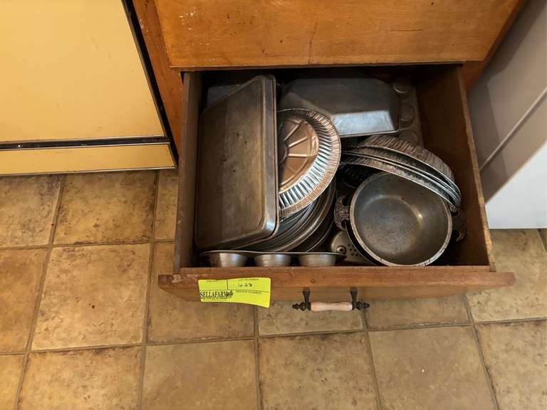 Bottom drawer of cabinet filled with metal baking items (1 piece of Guardian Ware)