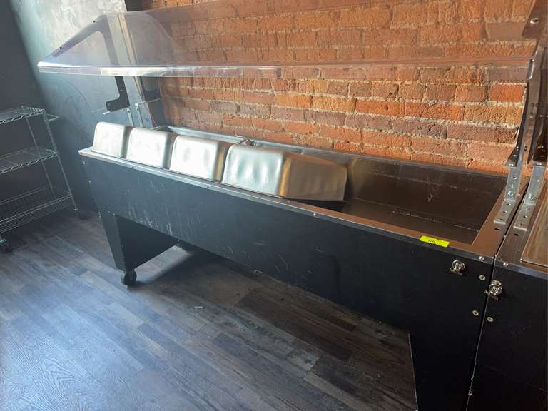 Ice Cooled Portable Food Buffet Table, 77-3/4"W x 35"D x 53"H, double sided sneeze guard, accommodates (5) 12" × 20" pans inserts up to 6-1/4" deep (with additional space below for ice), 8" deep well, 1" IPS drain, open base, black vinyl clad finish, (4) 5" swivel casters (2) with brakes, NSF
5 ea SP-A Spillage Pan, 12"W X 20"D X 6-1/4"H, aluminum Weight: 425 Ibs total