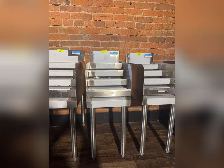 Underbar Liquor Bottle Display Unit, 12'W X 21-1/4"D x 32-1/2"H, (4) steps with guard rail, approximately (13) bottle capacity, 18/304 stainless steel construction, 1-5/8" diameter stainless steel legs & side crossbracing, adjustable plastic bullet feet, NSF Weight: 72 Ibs total