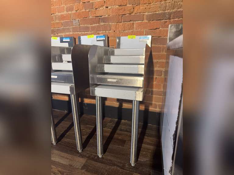 Underbar Liquor Bottle Display Unit, 12'W X 21-1/4"D x 32-1/2"H, (4) steps with guard rail, approximately (13) bottle capacity, 18/304 stainless steel construction, 1-5/8" diameter stainless steel legs & side crossbracing, adjustable plastic bullet feet, NSF Weight: 72 Ibs total