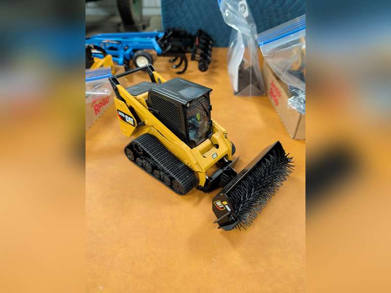 Diecast Masters 1:16 scale model of a Cat 297D2 Multi Terrain Loader with attachment accessories