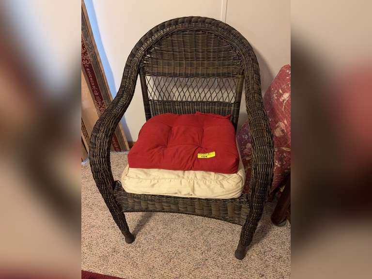Dark brown wicker chair with cushions