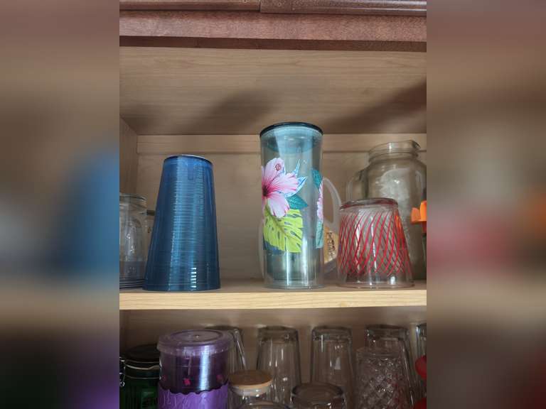 Top shelf of cabinet-Tupperware pitchers and glasses