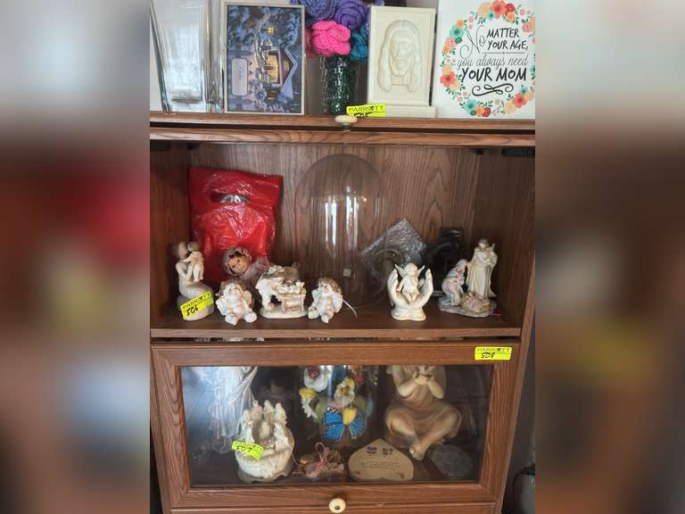Contents of top drawer (decorative religious items, willow tree grandmother figure, and more)
