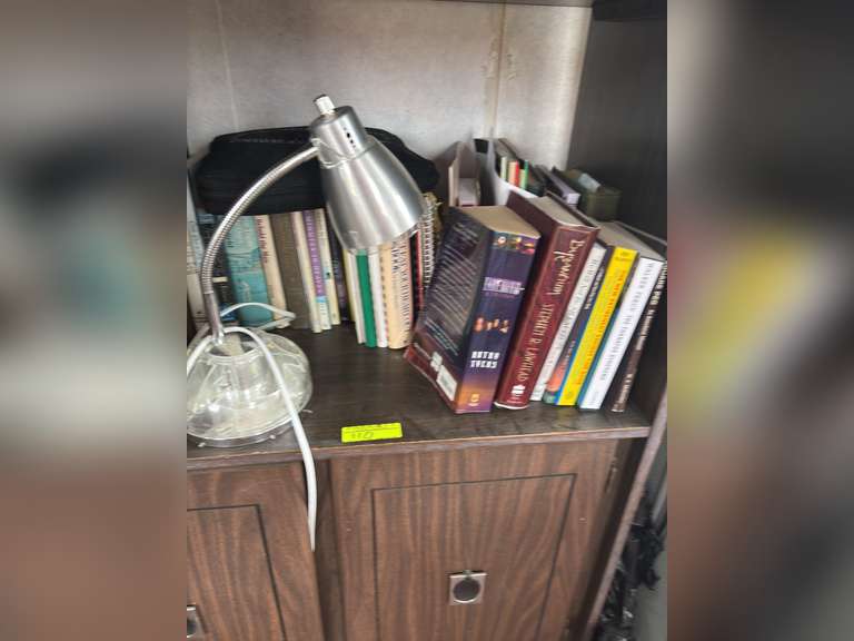Contents of shelf with books and lamp