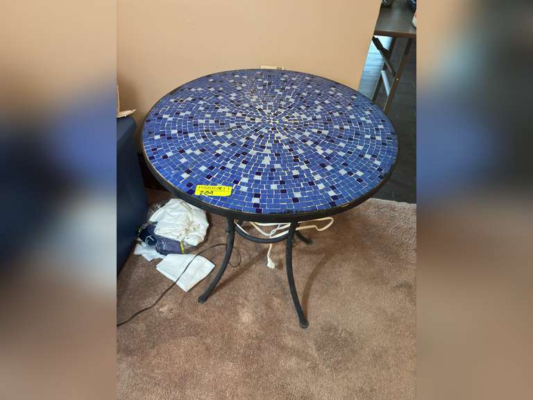 Black table with decorative blue tile top