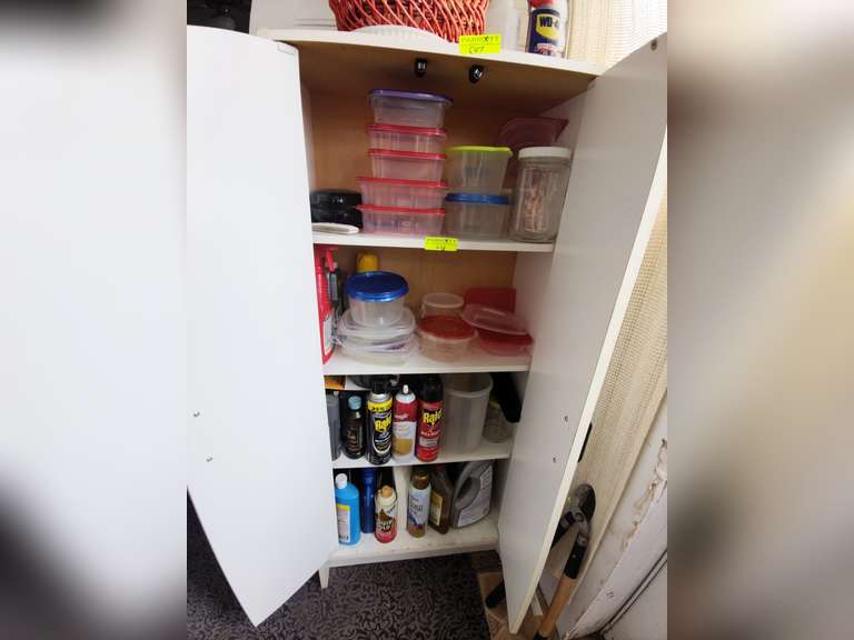 Contents of white storage cabinet
