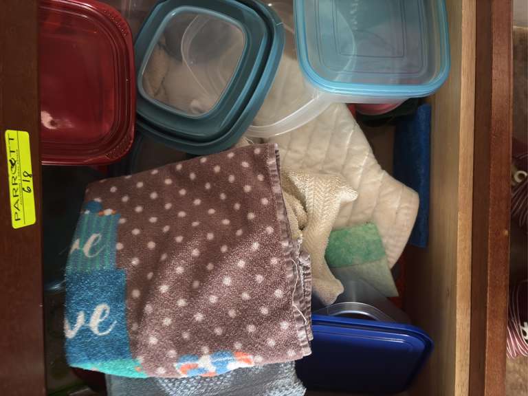 Bottom two drawers of kitchen cabinet (tools, oven rags, and plastic ware)
