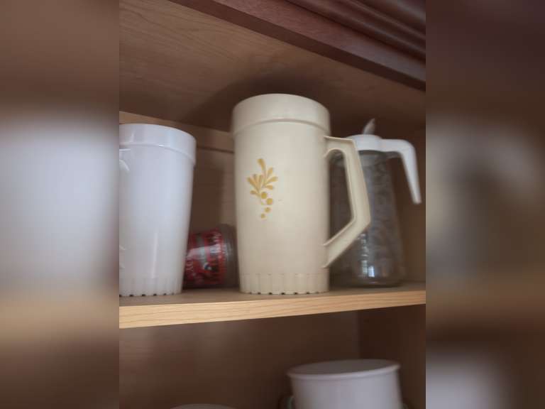 Top shelf of cabinet-Tupperware pitchers and glasses