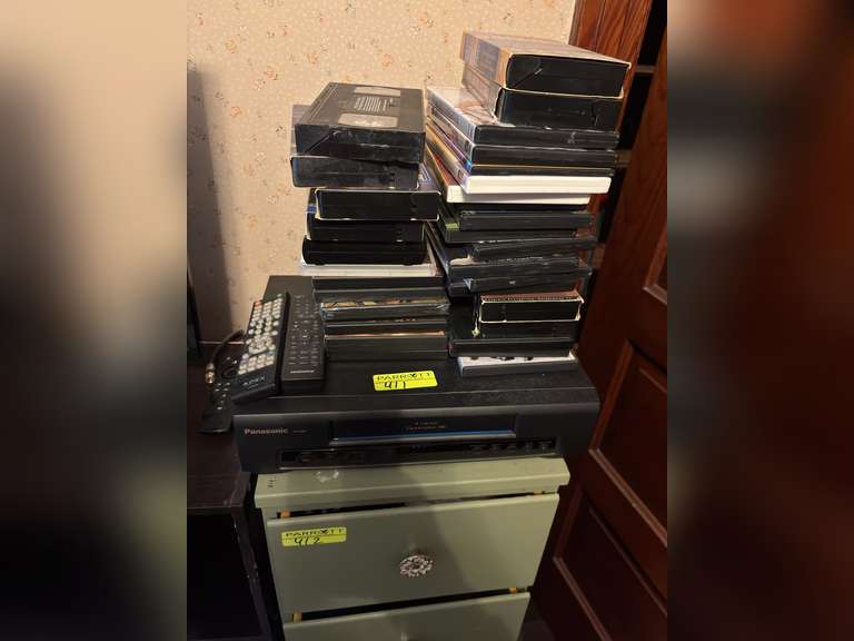Panasonic VHS player with variety of vhs tapes and DVDs
